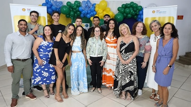 Um grupo de jovens em um fundo colorido, segurando uma placa de madeira